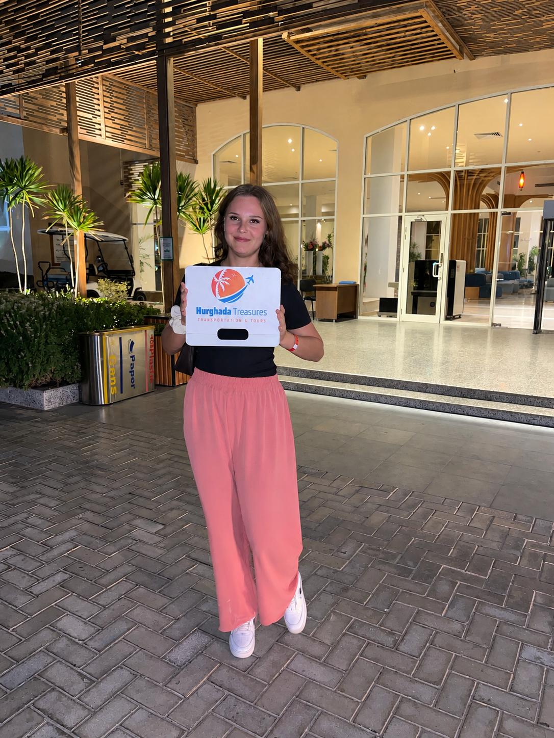 Guest holding Hurghada Treasures welcome sign