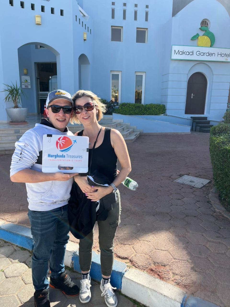 Couple with the Hurghada Treasures sign at Makadi Garden Hotel