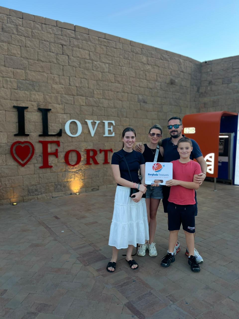 Family at the I Love Hurghada Fort sign after a private Hurghada Treasures city transfer