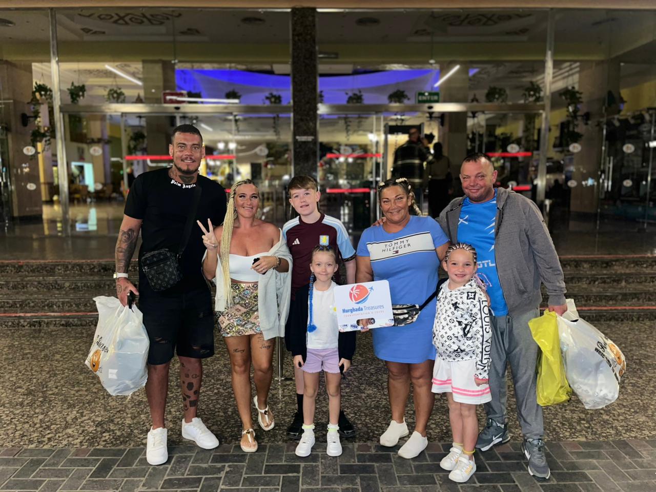 Family group with the Hurghada Treasures sign after a private city transfer in Hurghada