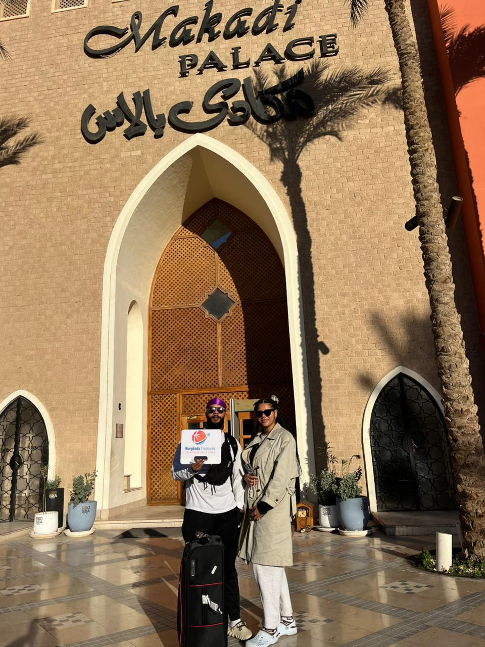 Couple with luggage at Makadi Palace before their private Hurghada Airport transfer
