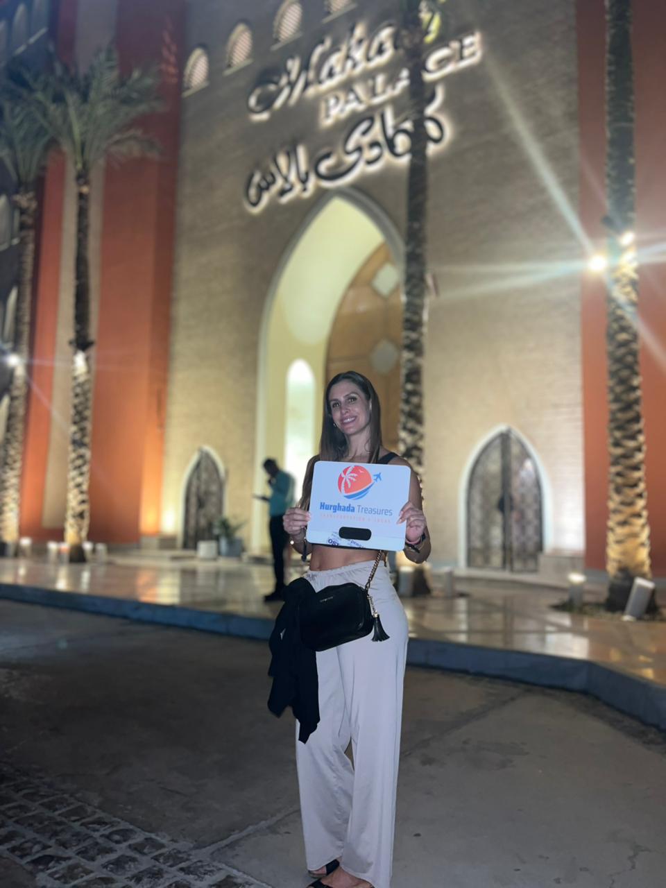 Guest with the Hurghada Treasures sign at Makadi Palace Resort entrance